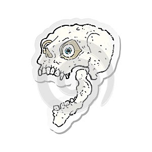 A creative retro distressed sticker of a cartoon scary skull