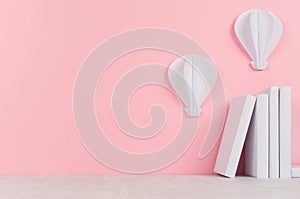 Creative school library - pile white blank books and decorative paper aerostats on pink background.