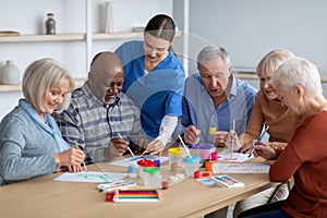 Creative senior men and women doing arts and crafts together