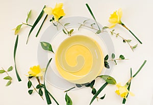 Creative spring concept ideas made of fresh yellow flowers and pastel plate bowl decoration isolated on white background .Flat lay