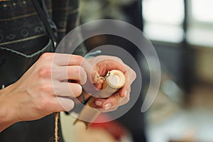 Creative student doing his project in workshop. Boy in the workshop makes crafts with coconut. School, development and learning