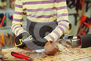 Creative student doing his project in workshop. Boy in the workshop makes crafts with coconut. School, development and learning