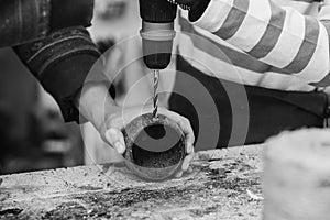 Creative student doing his project in workshop. Boy in the workshop makes crafts with coconut. School, development and learning