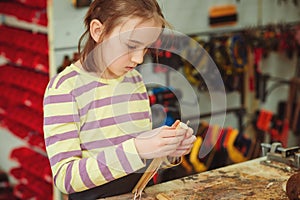 Creative student doing his project in workshop. Boy in the workshop makes crafts with coconut. School, development and learning
