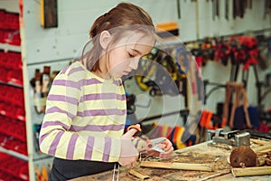 Creative student doing his project in workshop. Boy in the workshop makes crafts with coconut. School, development and learning