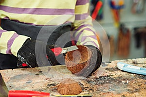 Creative student doing his project in workshop. Boy in the workshop makes crafts with coconut. School, development and learning