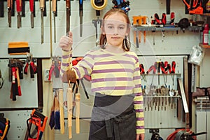 Creative student doing his project in workshop. Boy in the workshop makes crafts with coconut. School, development and learning