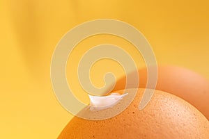 Creative sunscreen concept. Brown eggs like thighs. A drop of cream on the front buttock.