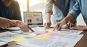 Creative team brainstorming and planning user interface and experience for mobile application development