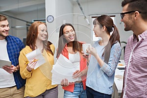 Creative team on coffee break talking at office