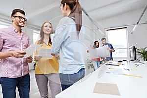 Creative team on coffee break talking at office