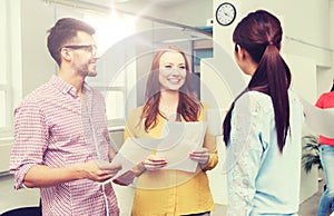 Creative team on coffee break talking at office