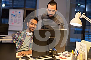 Creative team with computer working late at office