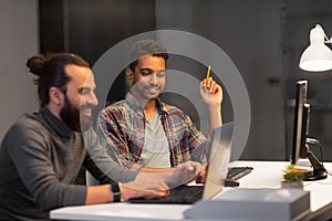 Creative team with computer working late at office