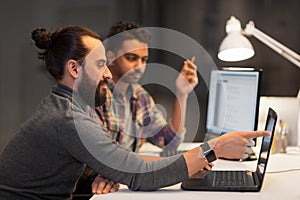 Creative team with computer working late at office