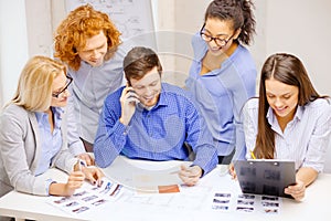 Creative team with papers and clipboard at office