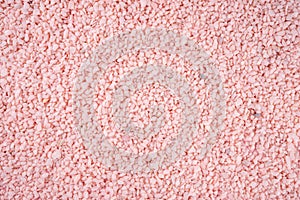 Creative texture background, pink pebbles or coarse sand