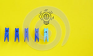 Creative thinking idea and problem solving innovation concept. Miniature figure outstanding from line with light bulb