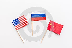 Creative top view flat lay of China, Russia and USA flags on white background in minimal style