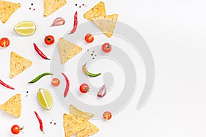 Creative Top view flat lay of fresh mexican food ingredients with tortilla nachos chips garlic pepper lime tomatoes on white table