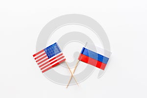 Creative top view flat lay of USA and Russia flags, mockup and copy space on white background in minimal style. Concept fight, war