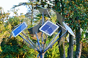 Creative, treelike solar panels in the city park photo