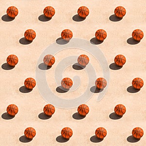 Creative trendy pattern made with basketball ball on concrete surface casting dark shadow on ground