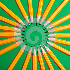Creative Unity - Yellow Pencils in a Circle on Green