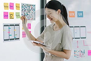 Creative ux designer brainstorming designing screens for mobile responsive website development with UI UX. Developing