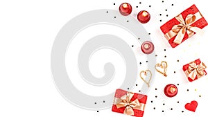 Creative Valentine`s Day greeting card with red decorations and gift boxes, golden heart confetti on white background, copy space