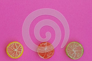 Creative view of colored candy in the form of citrus orange, li