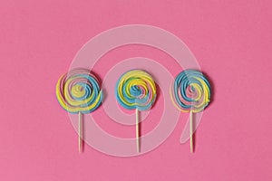 Creative view of colorful, handmade swirl lollipop in summer col