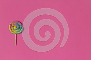 Creative view of colorful, handmade swirl lollipop in summer col