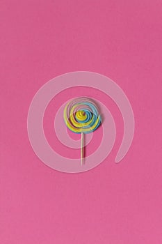 Creative view of colorful, handmade swirl lollipop in summer col