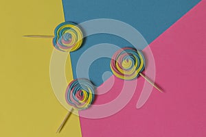 Creative view of colorful, handmade swirl lollipop in summer col