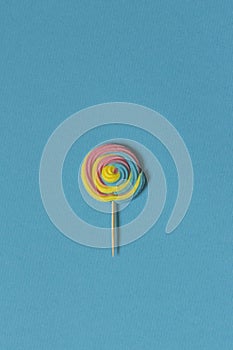 Creative view of colorful, handmade swirl lollipop in summer col