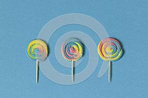 Creative view of colorful, handmade swirl lollipop in summer col