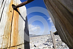 View from a set of old sea defences looking along the coastline of Conwy-side of Llandudno West Shore Beach, North Wales