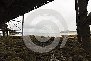 Creative view from underneath the Grade II Listed Llandudno Pier, North Wales