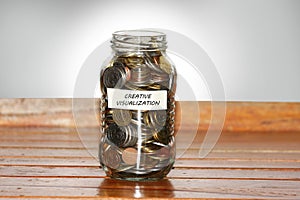 Creative visualization concept - jar full of coin photo