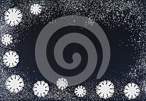 Creative winter snowflakes from powdered sugar background. Christmas and New Year backgrounds.