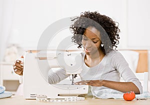 Creative woman using sewing machine