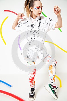 Creative woman in white clothes stained with colorful paint