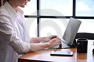 Creative woman working with computer laptop in modern office.