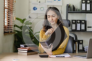 creative women\'s online desk using laptop computer licensing space Successful Asian businesswoman