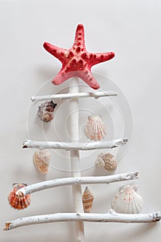 Creative wooden stick Christmas tree decorated with starfish and seashell. Master class and manufacturing process. overhead
