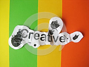 Creative word cut from paper
