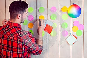 Creative worker using wall for brainstorm