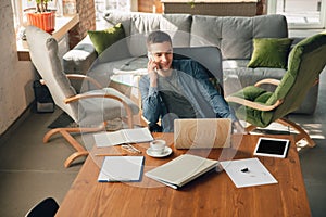 Creative workplace - organized work space as you like for inspiration, man working in office at messy table