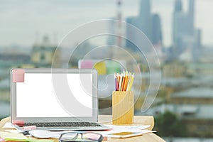 Creative workspace with empty white laptop